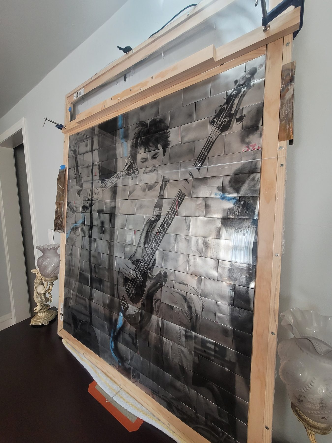 Side angle of framed aluminum mosaic showing depth and construction