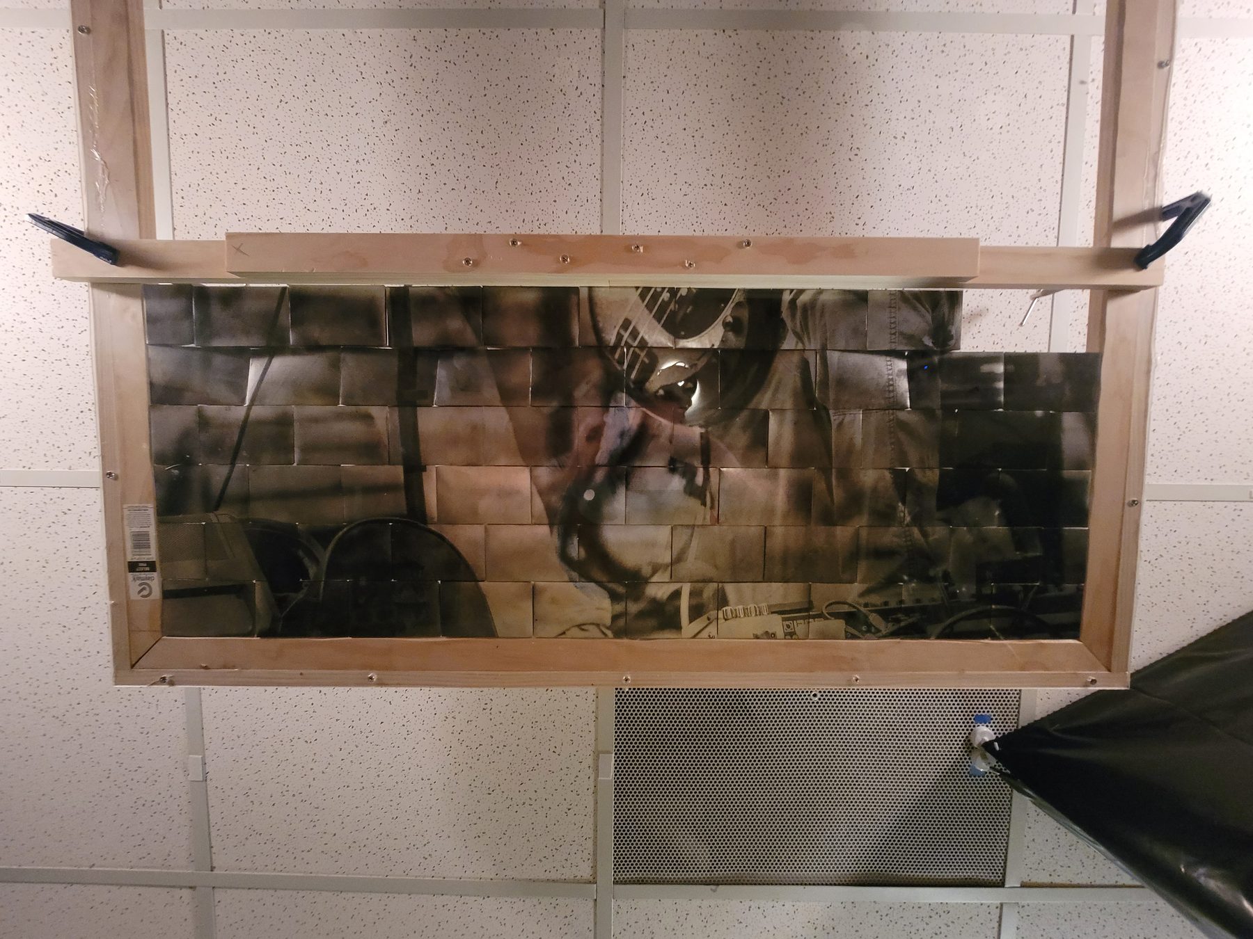 Framed reclaimed aluminum mosaic work on a wall